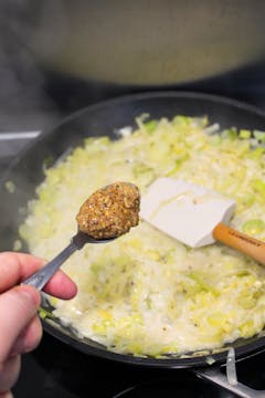 image of mustard being added to leek fondue