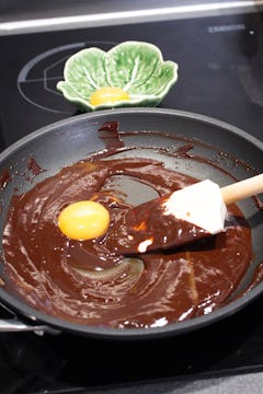 melted chocolate in a frying pan also with egg yolk