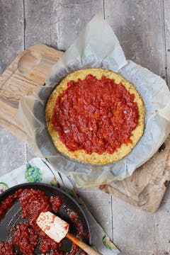 tomato sauce is added to the crust