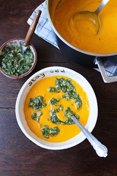Carrot soup with herb pesto in an Oddbox bowl with spoon