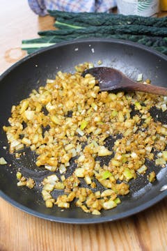 onion and spices in frying pan