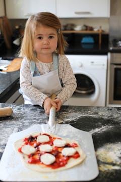 little girl with homemade pizza