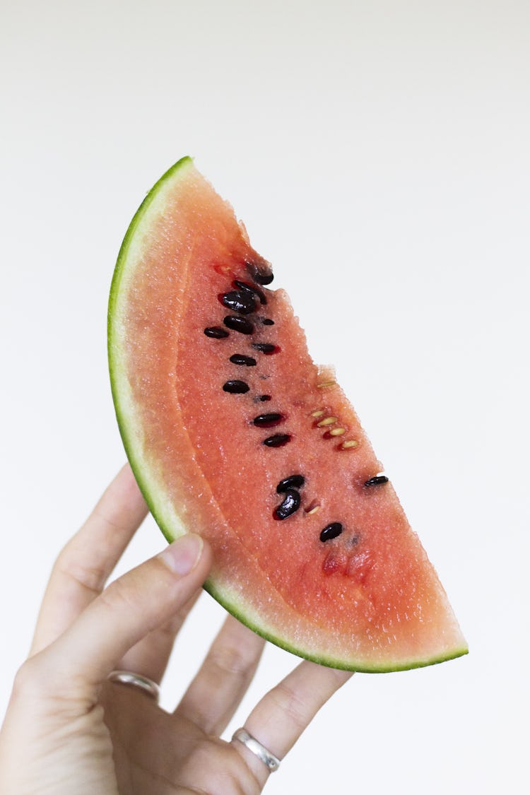 a piece of watermelon with seeds 