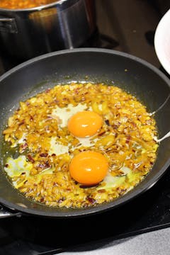 onion and eggs in pan 