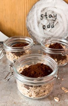oats and cocoa powder in glass jars