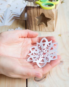 paper snowflake in a child's hand