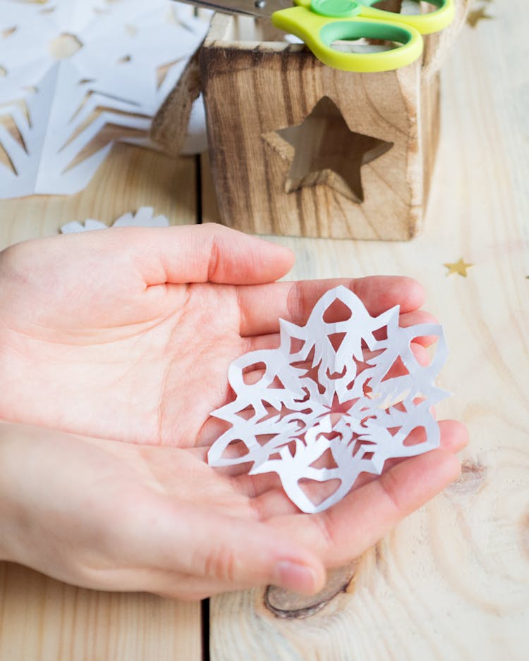 paper snowflake in a child's hand