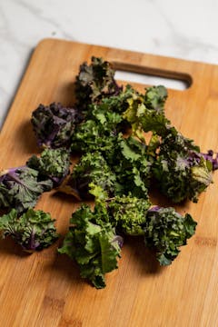 halved kalette on a wooden chopping board