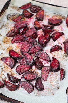 beetroot wedges on a baking tray with seasoning