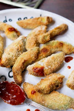 Crispy Baked Avocado Fries with Harissa Dipping sauce on a white plate