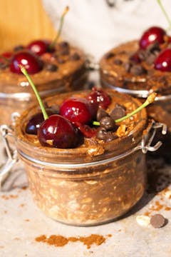 cherry and chocolate overnight oats topped with fresh cherries