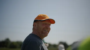 farm director with cap on smiling