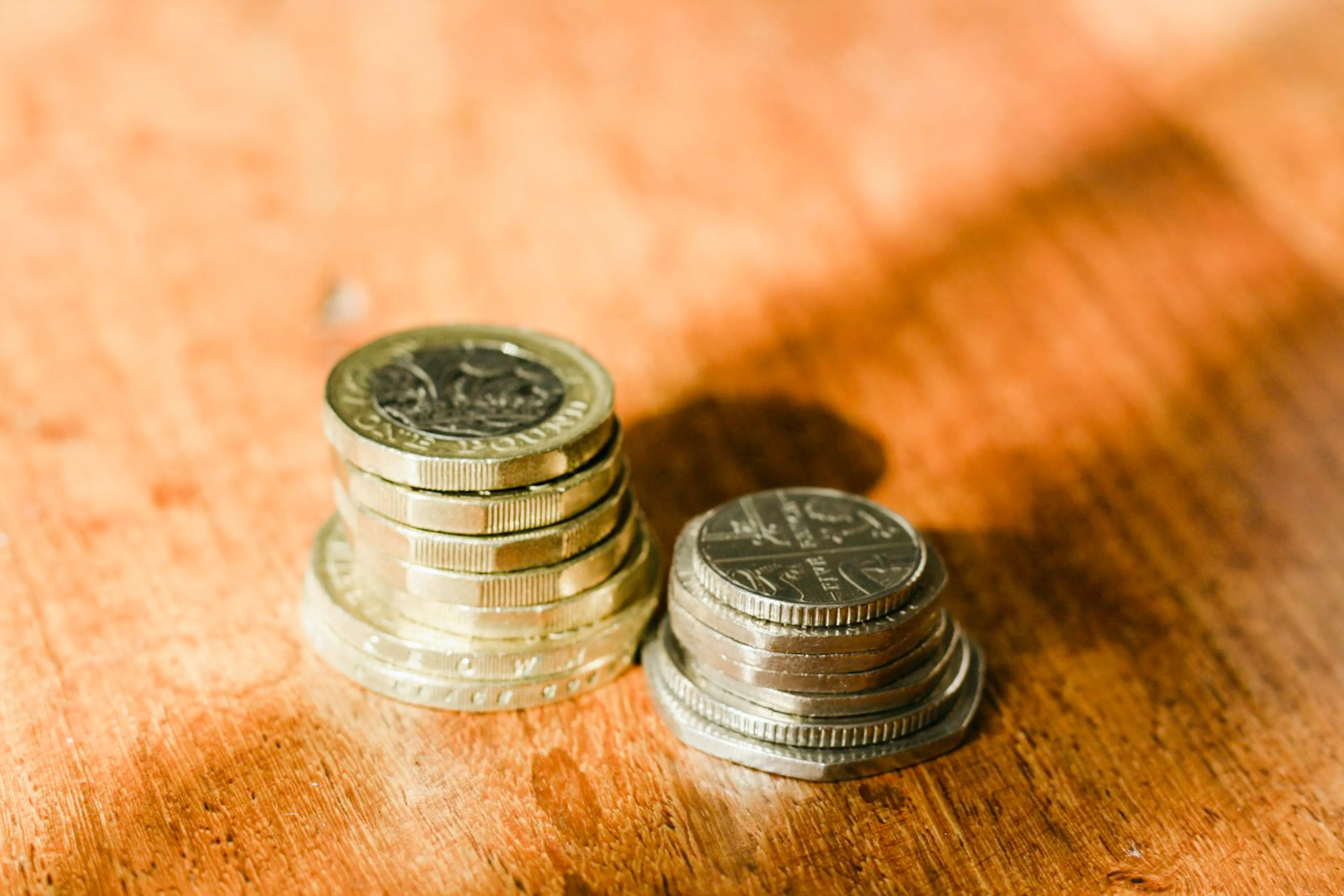UK pound coins and twenty pence pieces on a surface