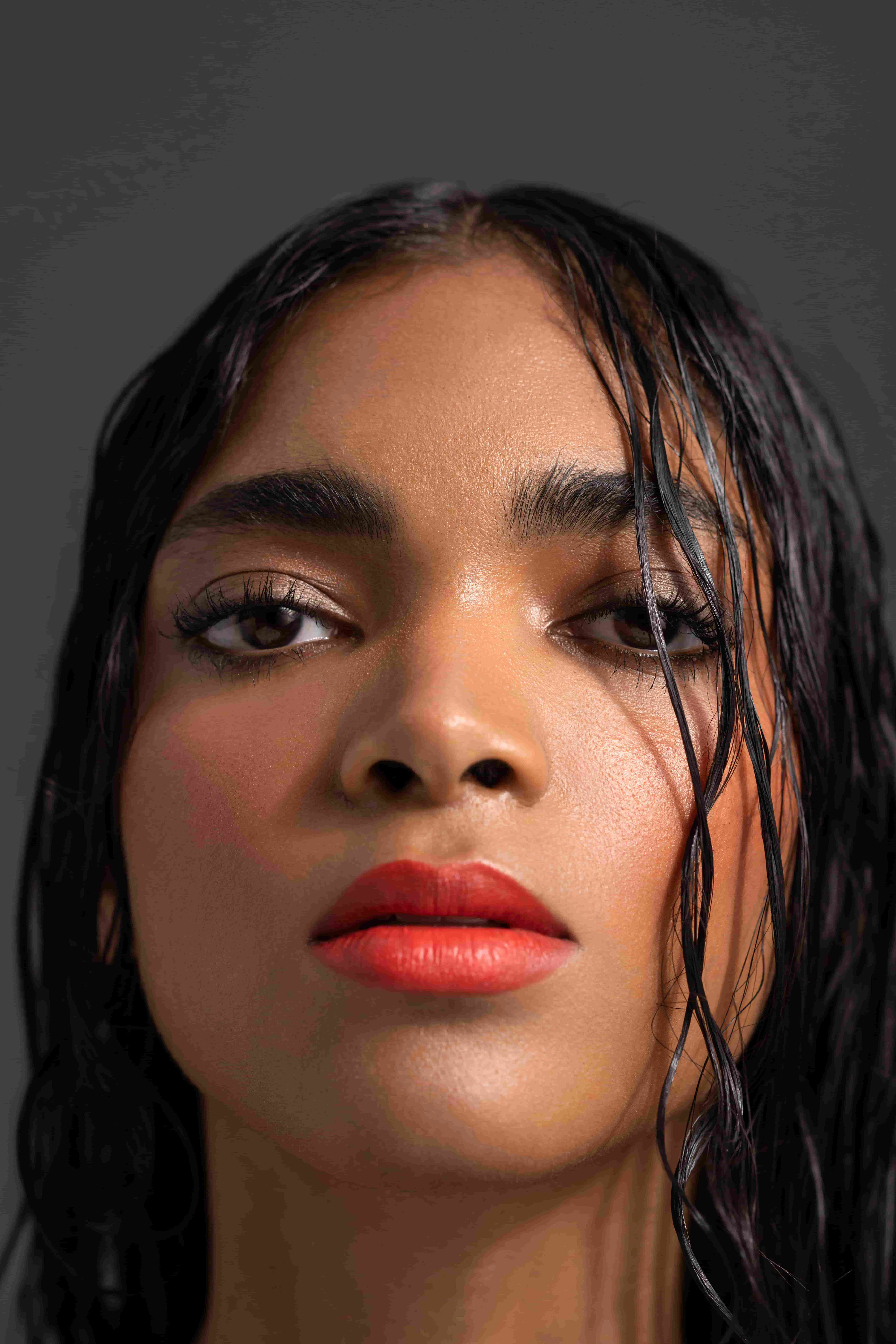 Model with wet hair and red lips