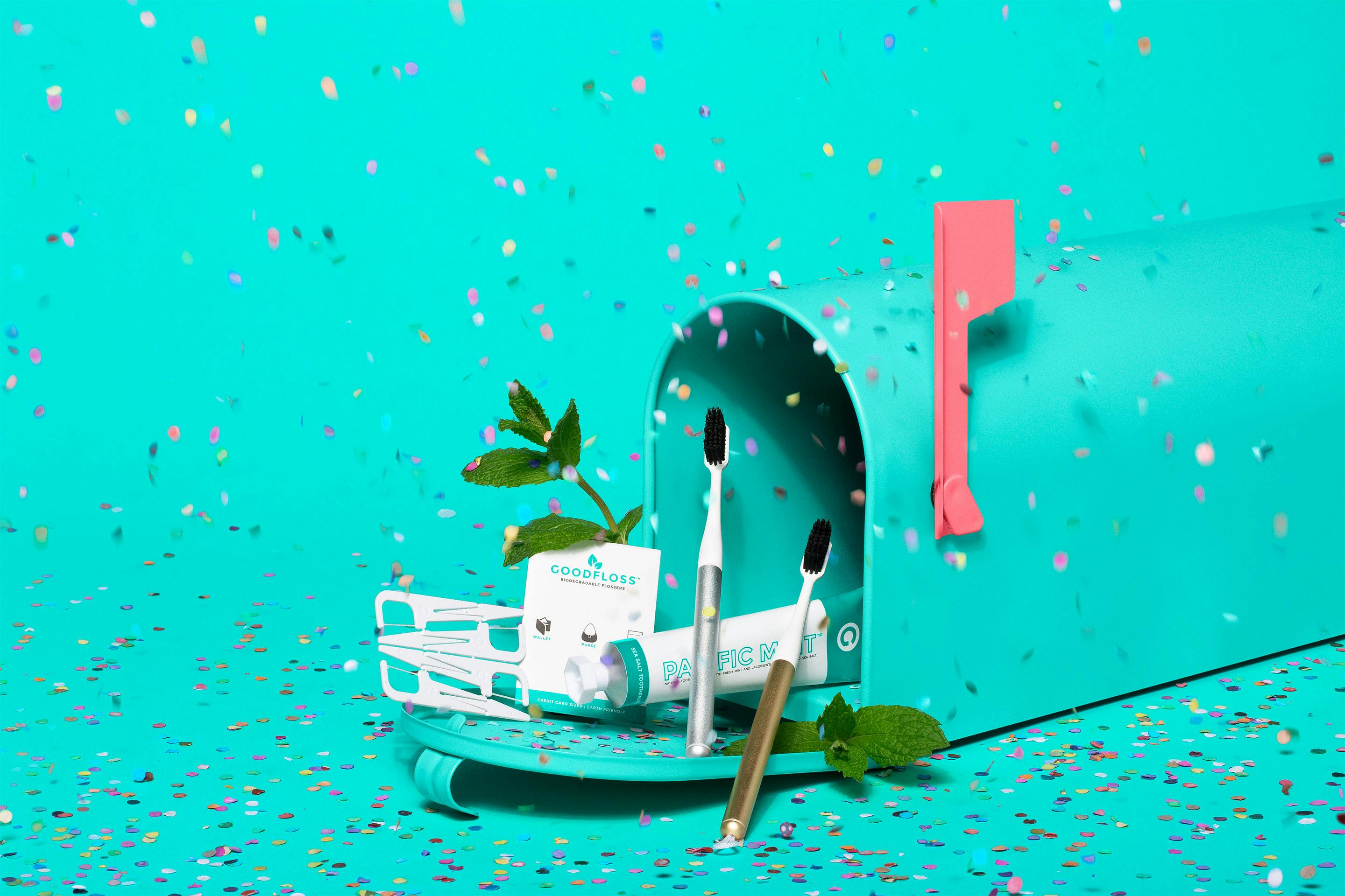 Toothbrushes in a mailbox and confetti falling, showcasing Goodwell products.