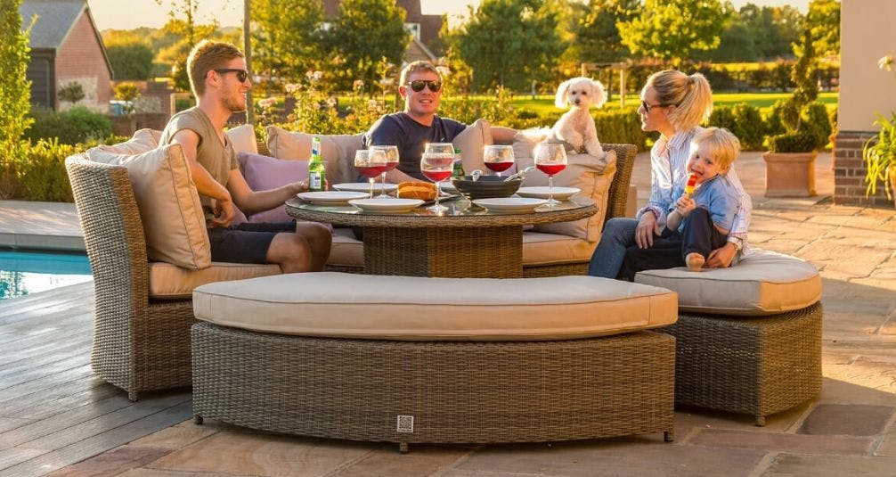 Family sitting on hamilton lifestyle round garden furniture set