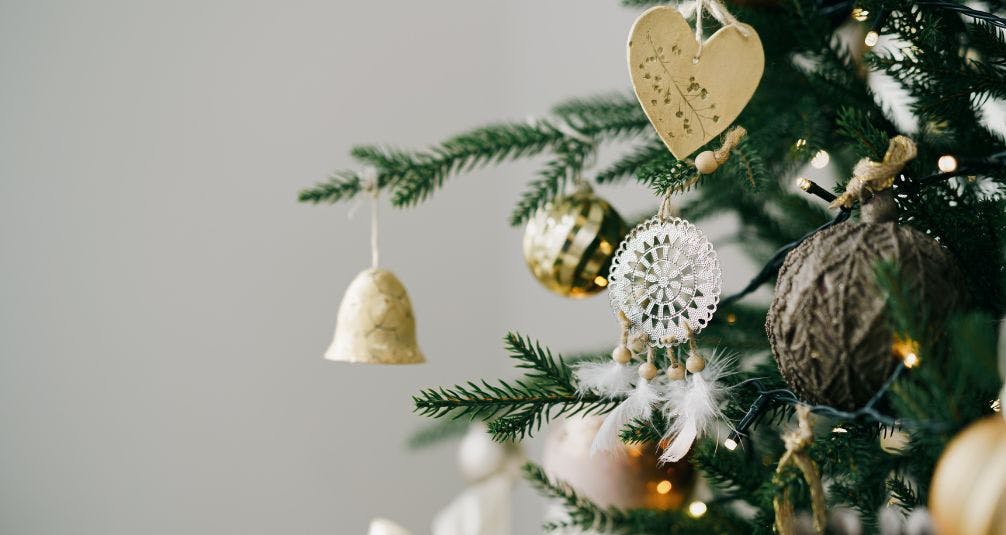 Gold decorations on artificial christmas tree