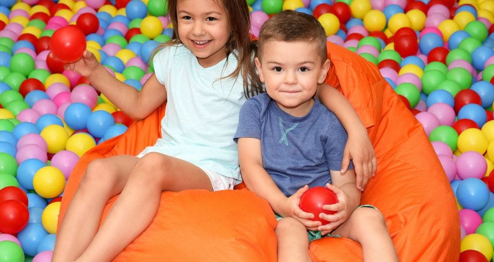 Children in ball pit sitting on beanbag