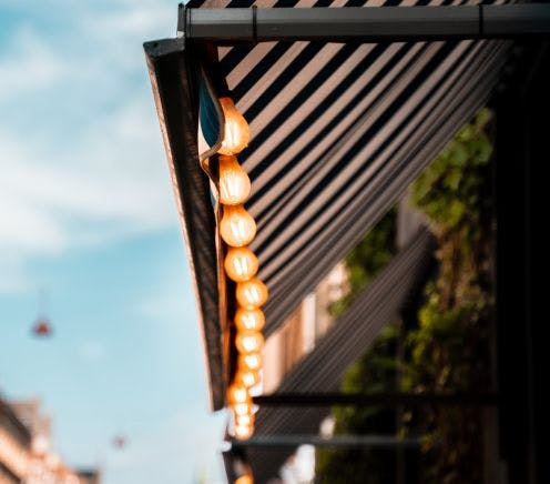 String lights hanging from awning