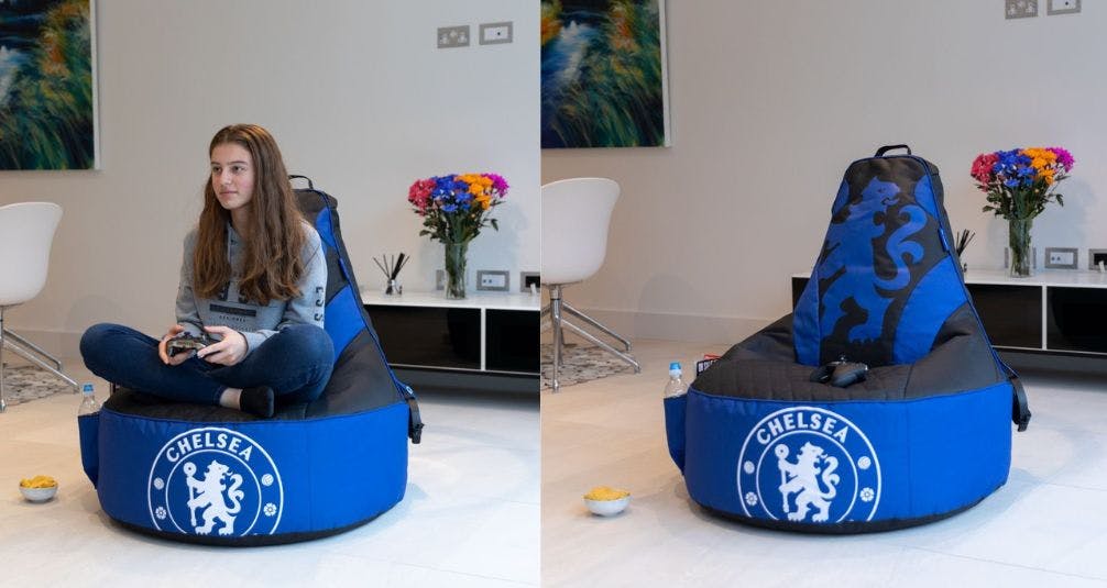 Girl playing games on chelsea fc beanbag
