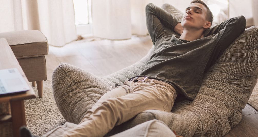 Man lazing on beanbag in living room