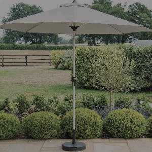 Parasol in base on patio