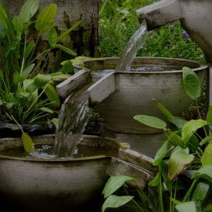 Three tier composite resin water feature in garden setting