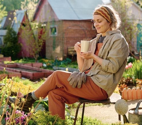 Woman enjoying coffee in sunny garden