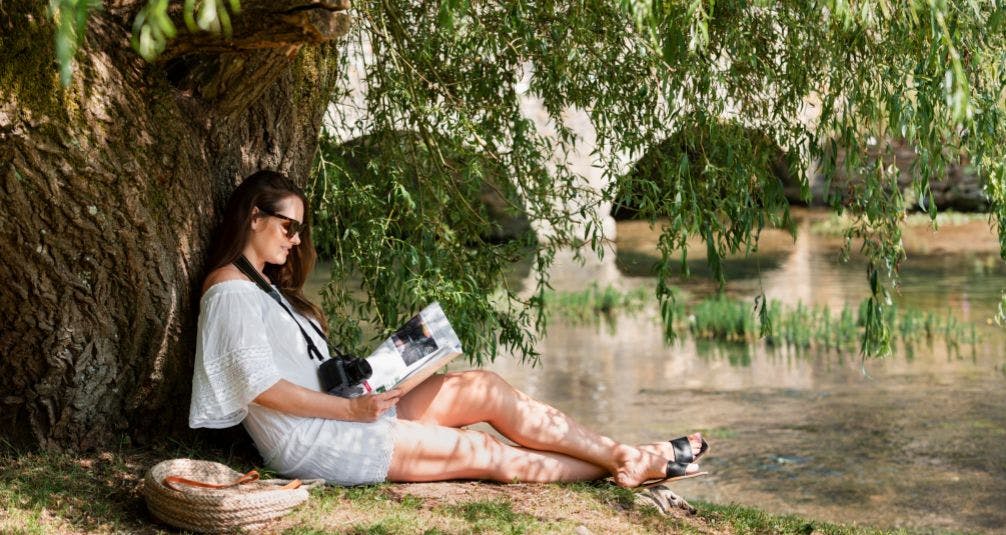 The Benefits of the Great Outdoors woman reading under tree