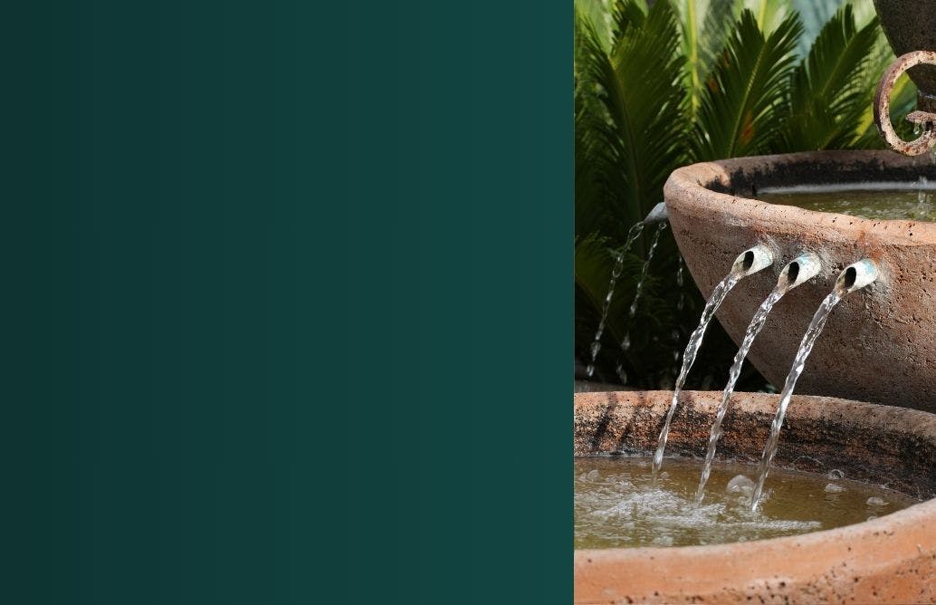 Garden water features close up to water pouring out of nozzle