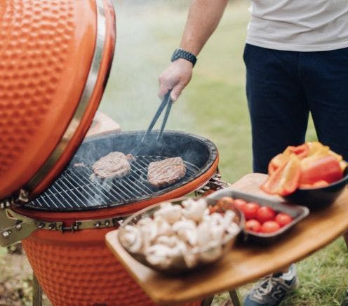 Close up of man cooking on kamado joe bbq grill