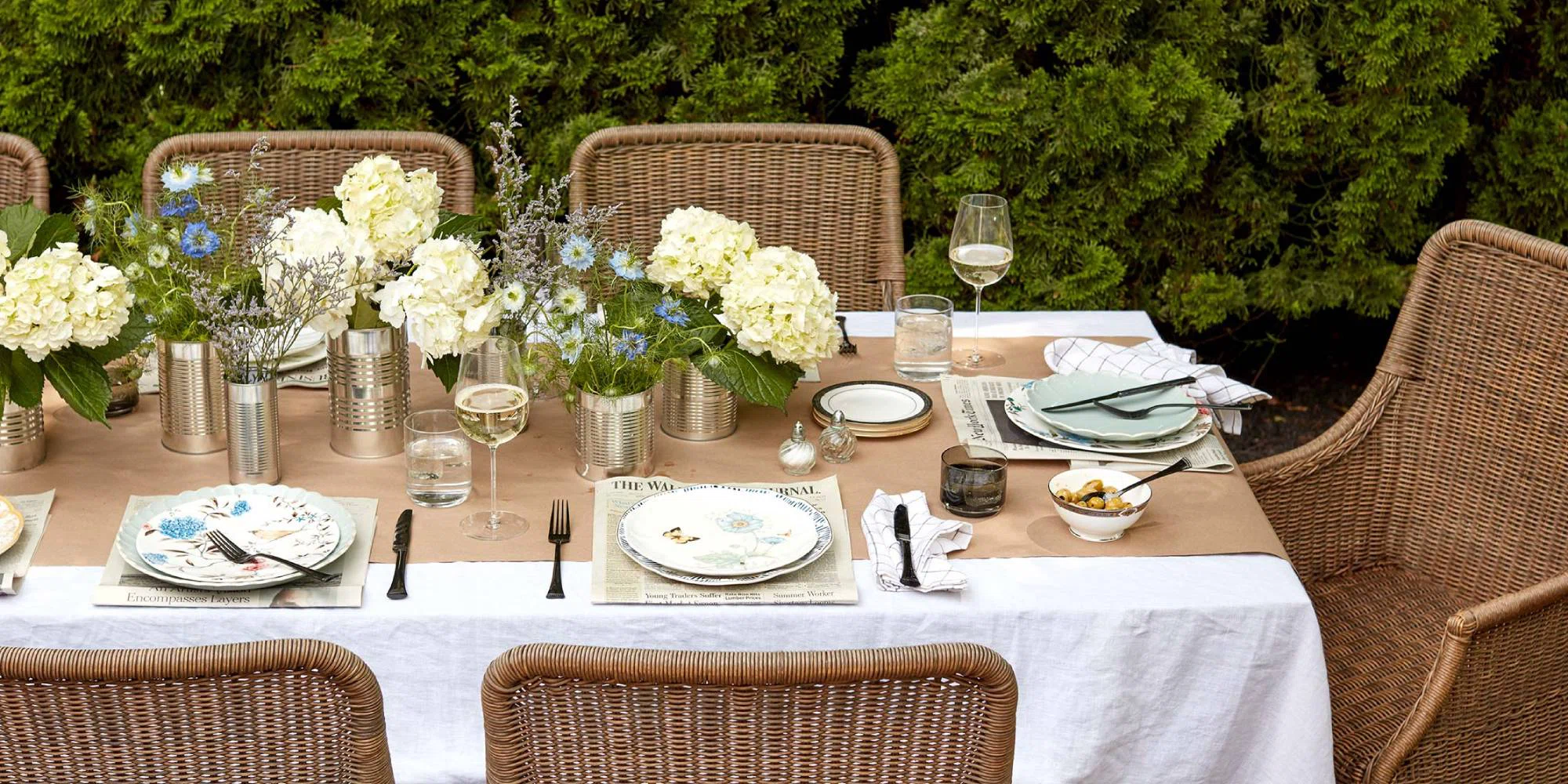 outdoor dining table setting with cream and blue flowers