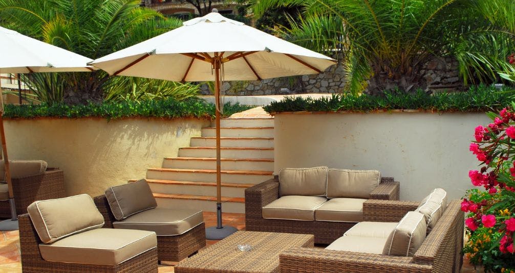Wooden parasol and rattan furniture