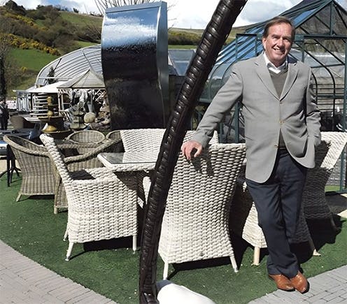 Pat kelly standing beside furniture set