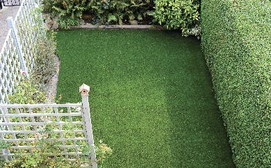 Small back garden with artificial grass