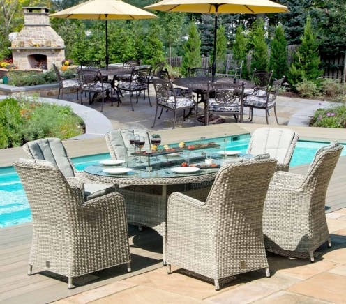 4 seat round rattan dining set beside pool
