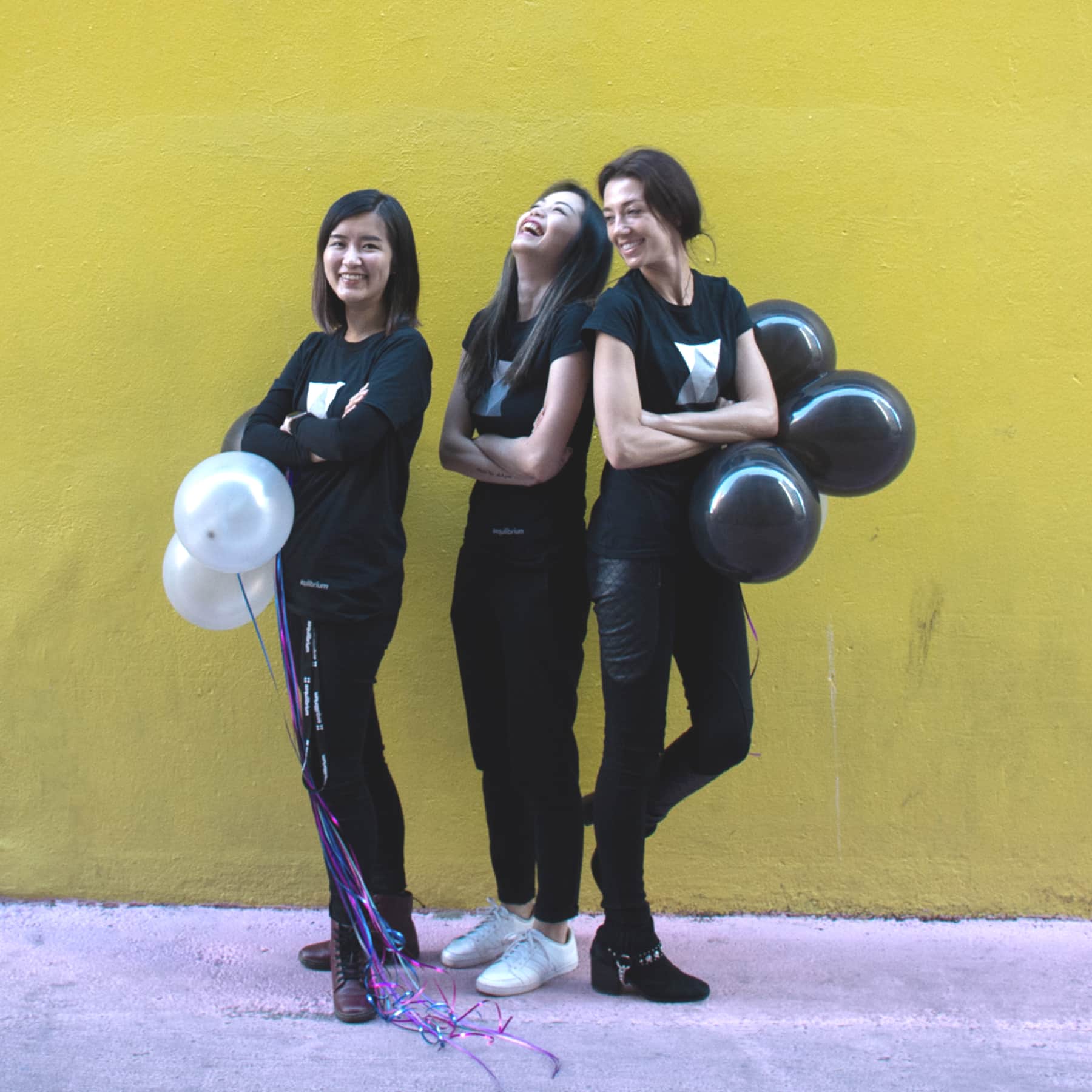 Three women smiling with balloons