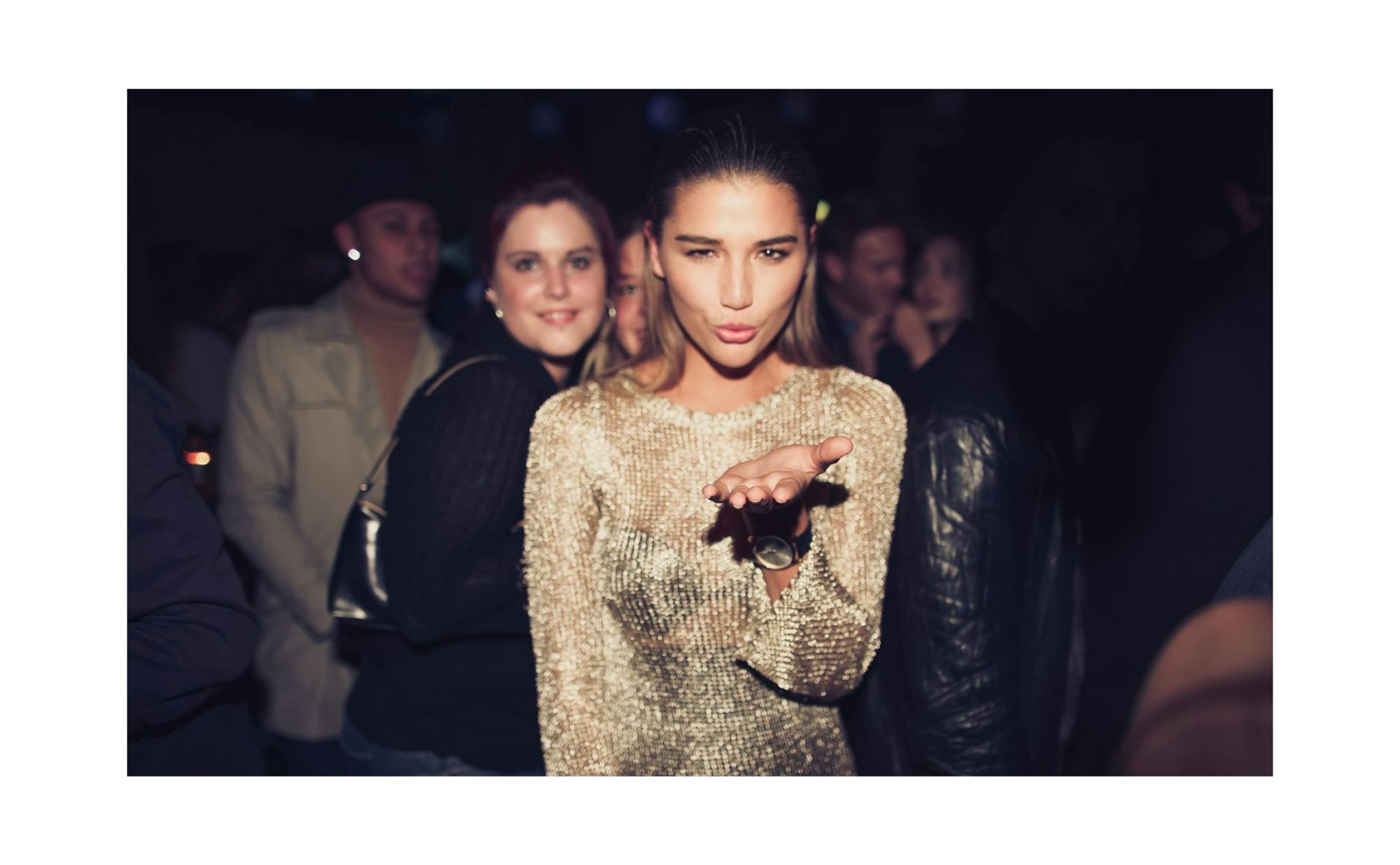 Young woman in gold dress at nighclub