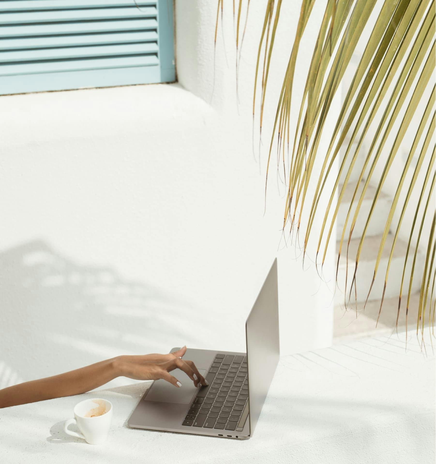 Hero image of womans hand on laptop