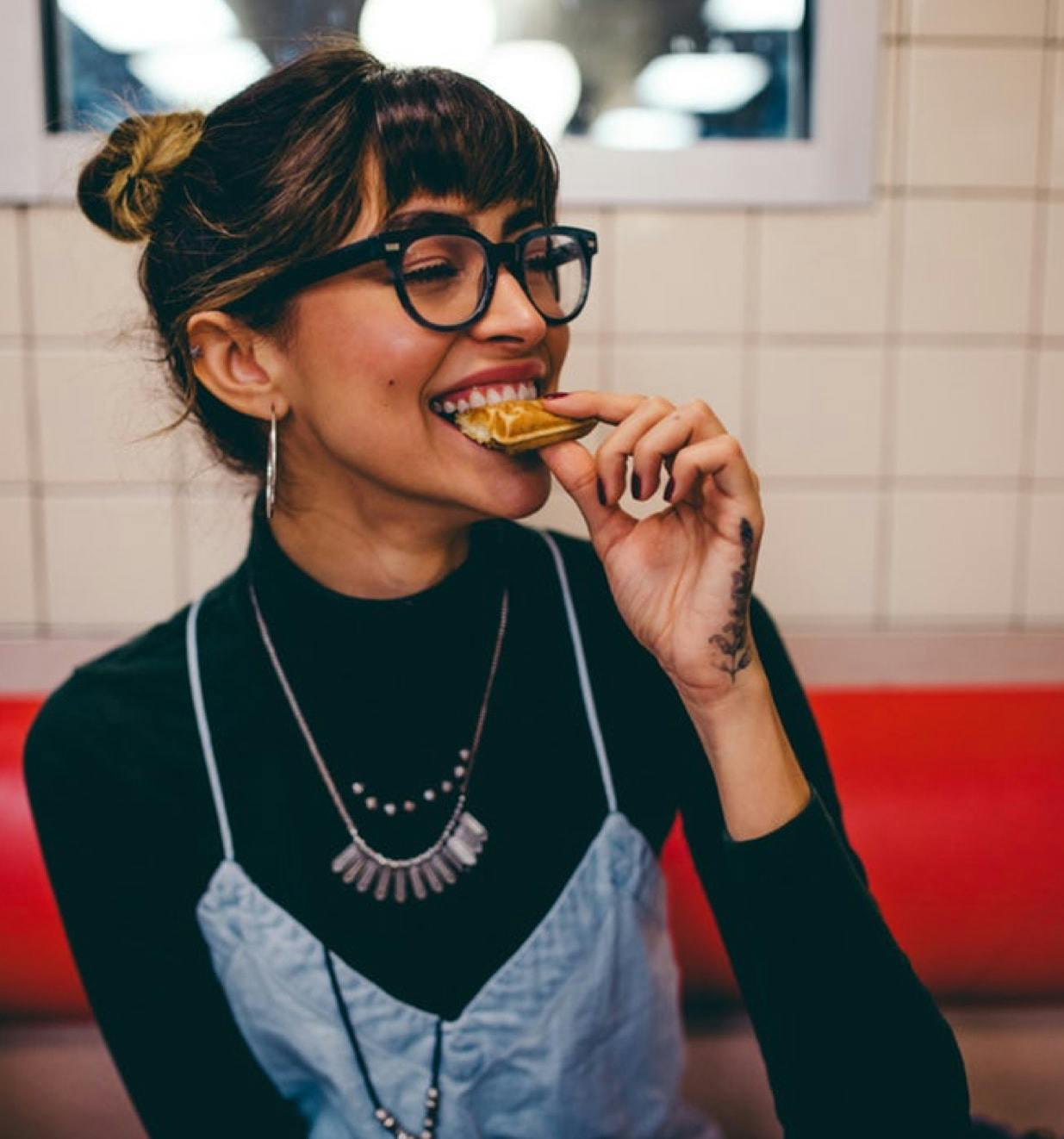 Hero image showing hipster girl eating waffles