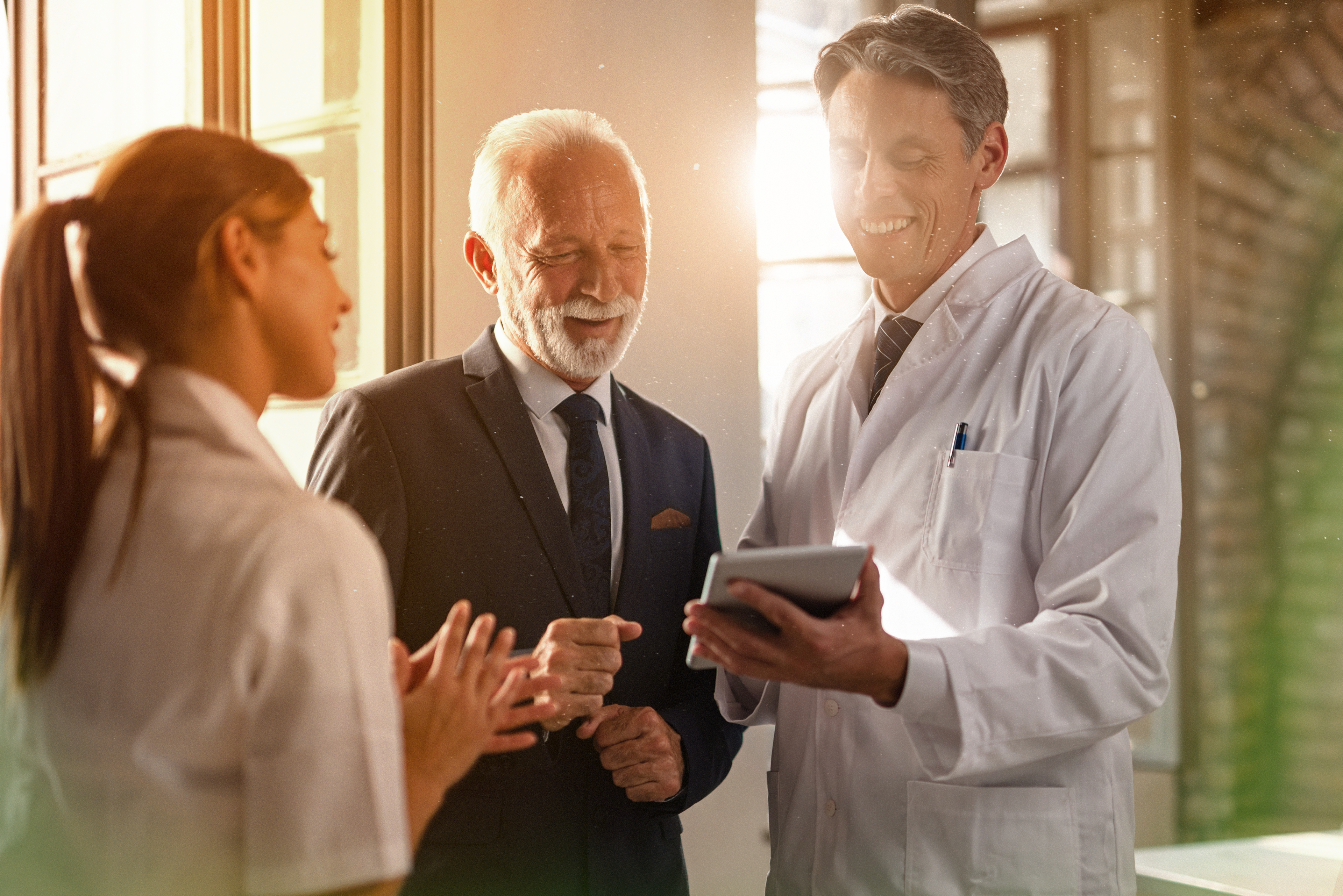 three doctors looking at tablet