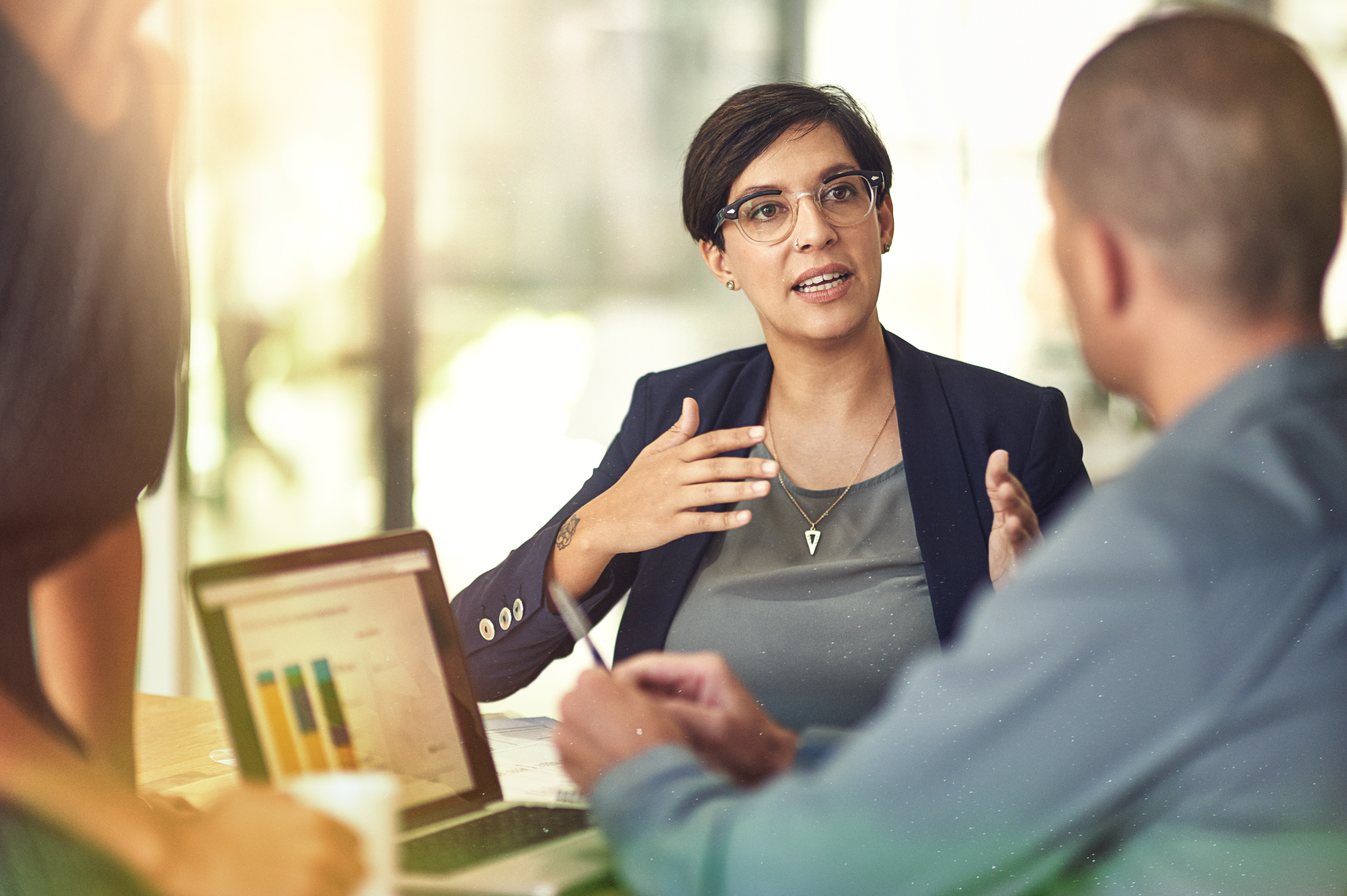 lady with glasses speaking in meeting