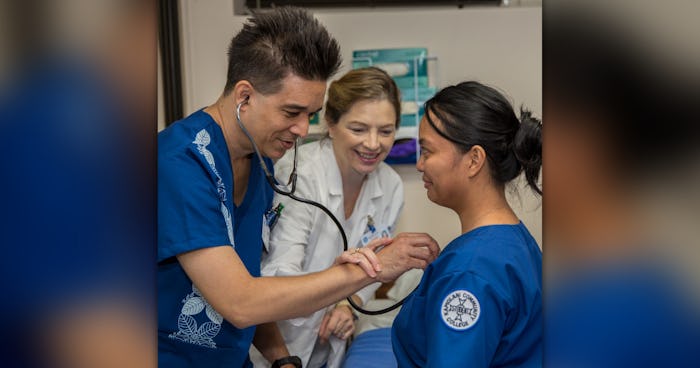 Nursing school students train on using a stethoscope.