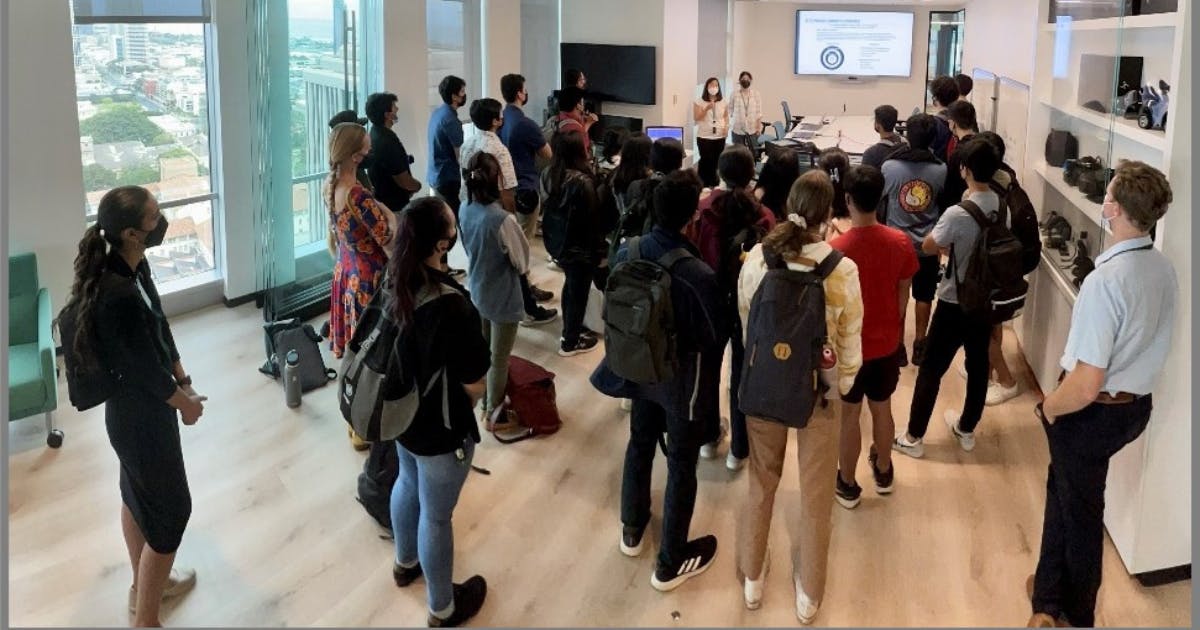 Photo of student interns presenting to high school students in an innovation lab.