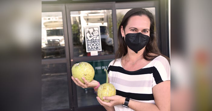 Photo of Amy Marvin in front of Hawai‘i Foodbank warehouse