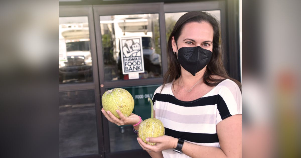 Photo of Amy Miller in front of Hawai‘i Foodbank warehouse