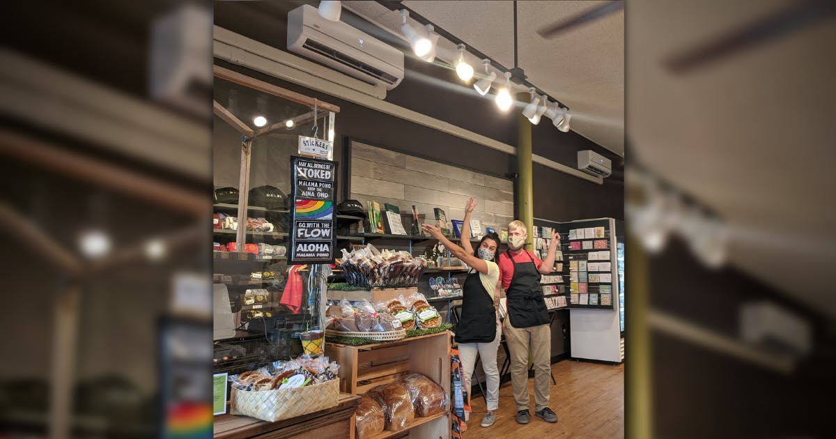 Photo of store employees showcasing new energy-efficient light fixtures