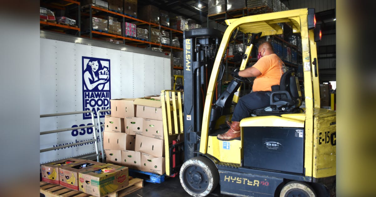 Photo of a pallet of produce being loaded in the Hawai‘i Foodbank warehouse