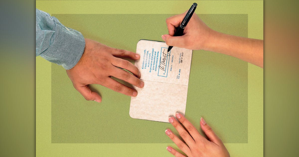 Image of a person signing a tourism document