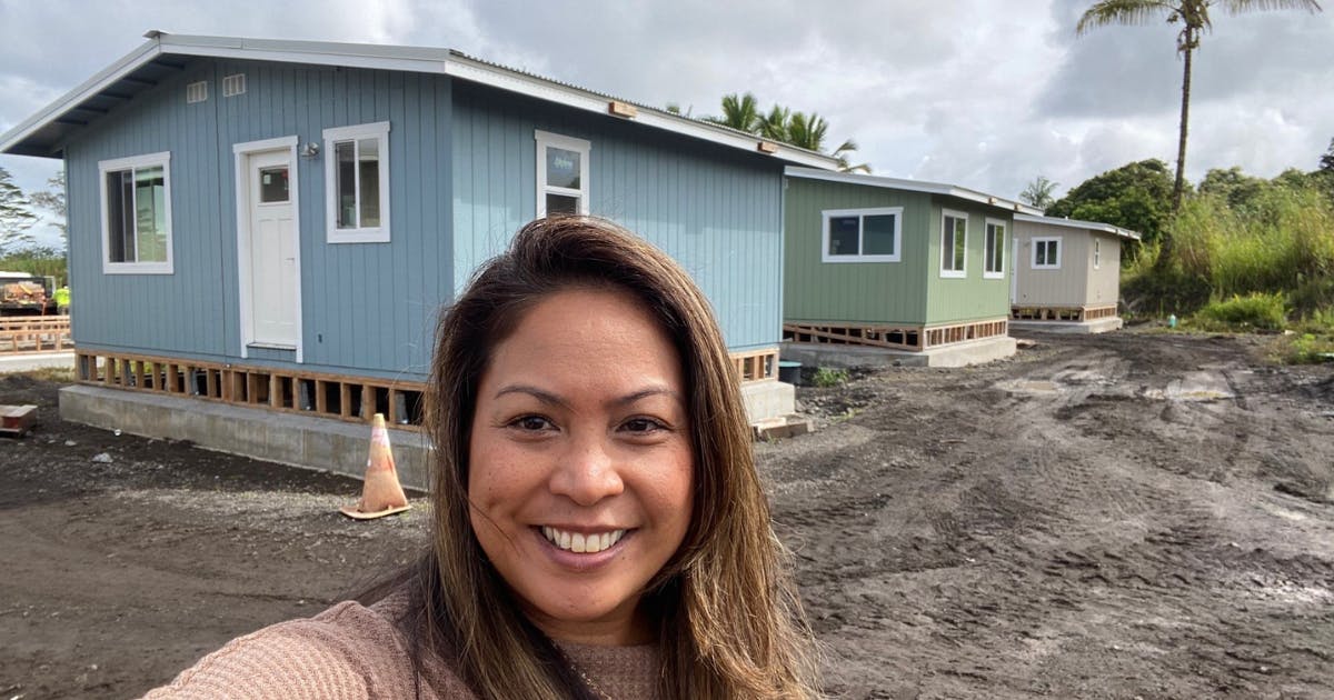 Photo of Brandee Menino standing in front of newly built modular homes in an affordable housing project in Pāhoa, Hawai‘i Island